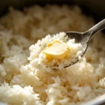 Freshly cooked Japanese rice with melting butter in a rice cooker